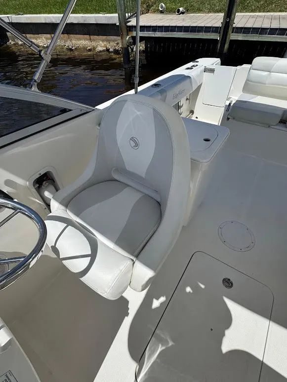 Slide: The Image of 2009 Edgewater 245 CX boat interior with white seating and steering wheel. - 24