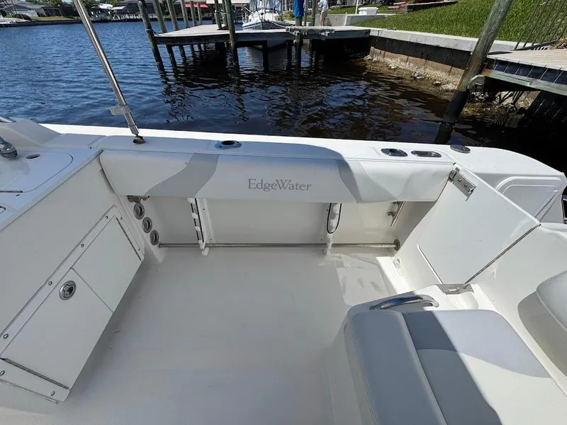 Slide: The Image of Edgewater 245 CX boat interior, 2009 model, featuring spacious seating and storage by the water. - 30