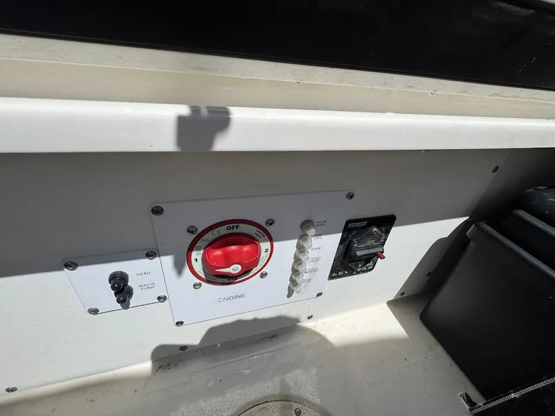 Slide: The Image of Control panel of a 2009 Edgewater 245 CX boat with switches and dials. - 36