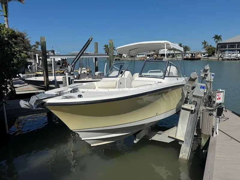 Slide: The Image of Edgewater 245 CX 2009 boat docked at marina, sunny day, calm water, palm trees in background. - 39