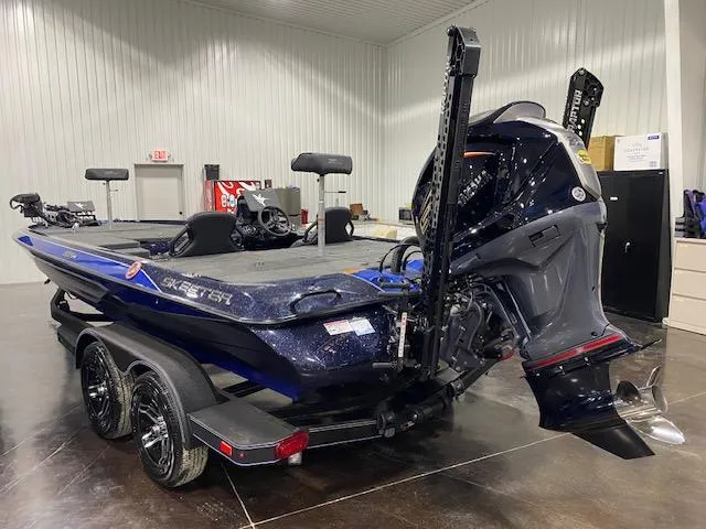 Slide: The Image of 2025 Skeeter ZXR 21 boat in showroom, featuring sleek design and powerful outboard motor. - 2