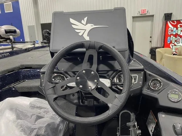 Slide: The Image of Steering wheel of 2025 Skeeter ZXR 21 boat, featuring modern dashboard and controls. - 4