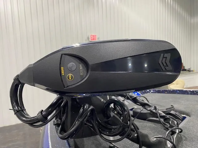 Slide: The Image of 2025 Skeeter ZXR 21 boat motor with control panel and cables in a garage setting. - 6