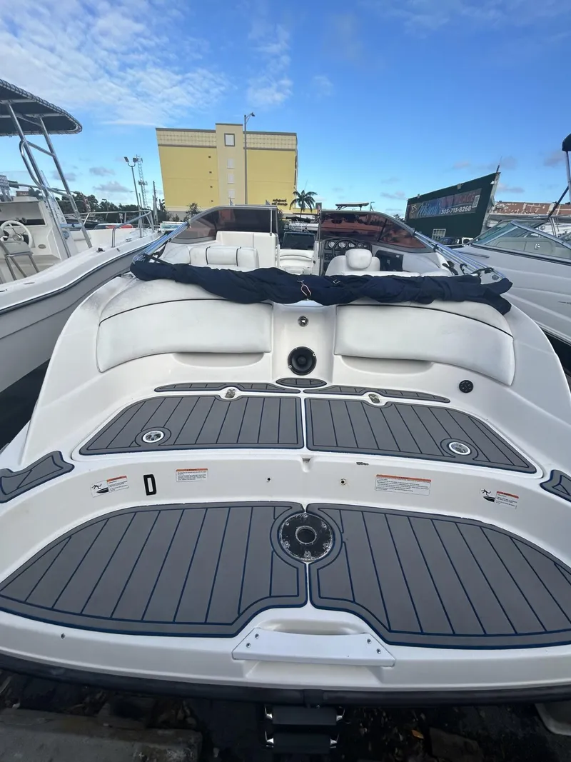 Slide: The Image of 2007 Yamaha Boats SR-230 with spacious deck, docked at marina under clear blue sky. - 3