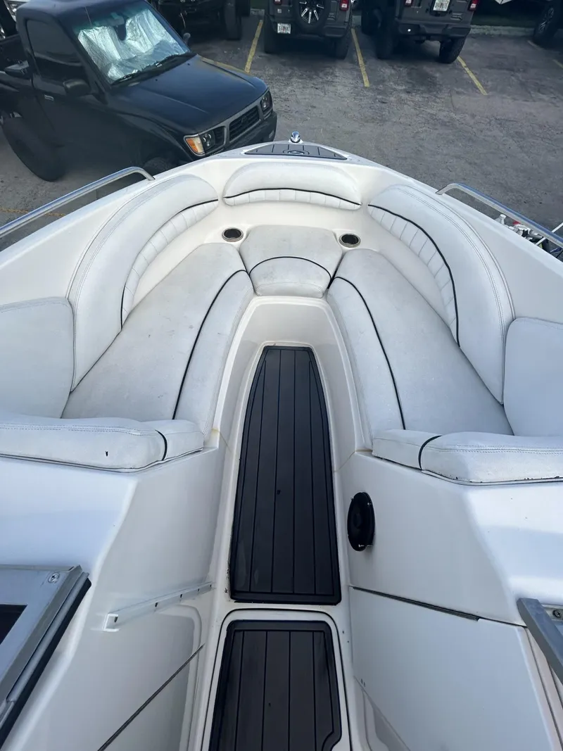 Slide: The Image of 2007 Yamaha Boats SR-230 interior with white seating and black flooring. - 6