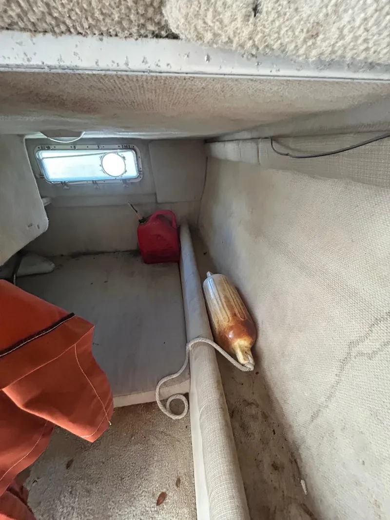 Slide: The Image of Interior cabin of 2002 Wellcraft 2400 Martinique boat with window and safety equipment. - 4