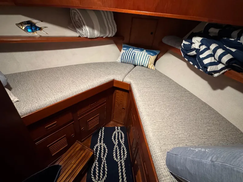 Slide: The Image of Cozy cabin interior of 1983 Marine Trader 44 Sundeck with cushioned seating and nautical decor. - 13