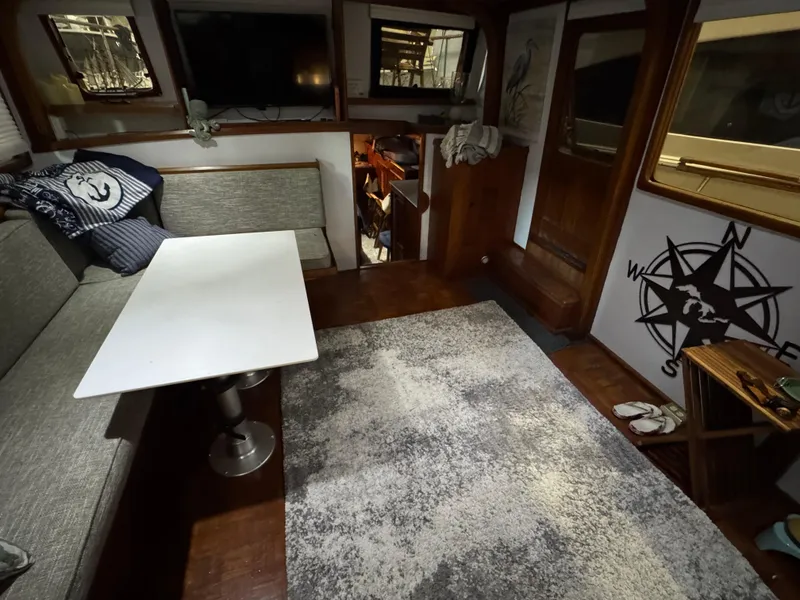 Slide: The Image of Interior of 1983 Marine Trader 44 Sundeck with cozy seating and nautical decor. - 21