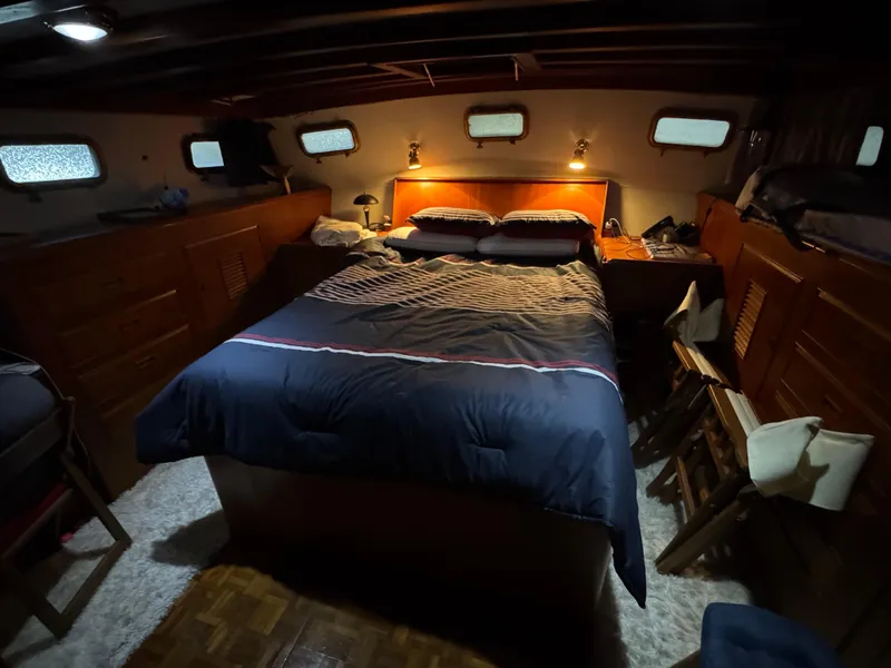 Slide: The Image of Cozy bedroom interior of 1983 Marine Trader 44 Sundeck yacht with wooden furnishings. - 23