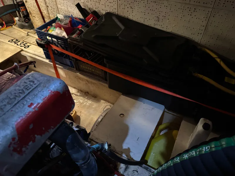 Slide: The Image of Engine room of 1983 Marine Trader 44 Sundeck with storage crates and equipment. - 29