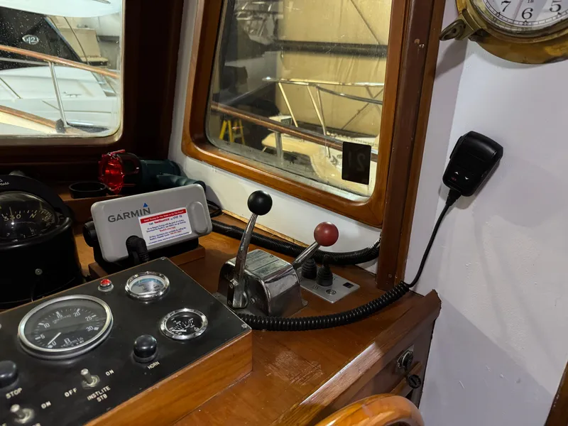 Slide: The Image of 1983 Marine Trader 44 Sundeck helm with Garmin navigation and control panel. - 9