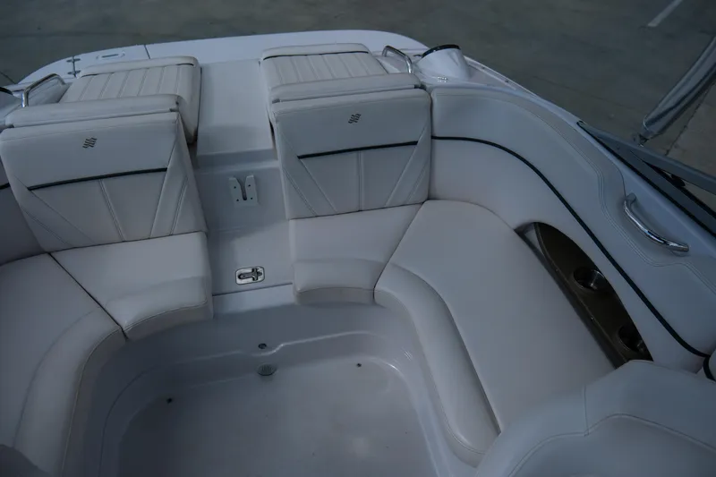 Slide: The Image of 2010 Four Winns 220H boat interior with white cushioned seating. - 10