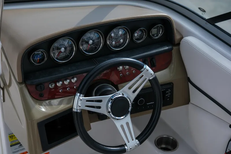 Slide: The Image of Steering wheel and dashboard of 2010 Four Winns 220H boat. - 14