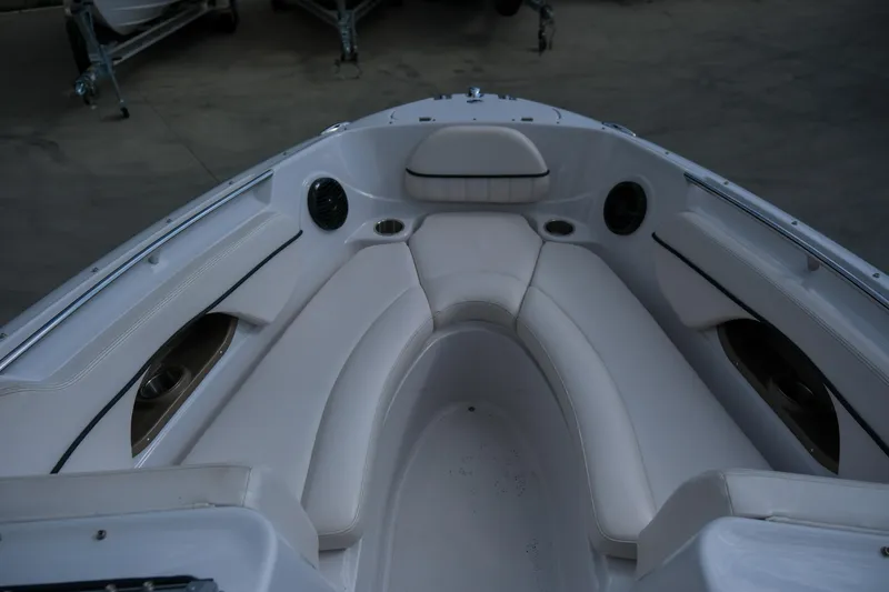 Slide: The Image of 2010 Four Winns 220H boat interior with white seating and cup holders. - 16