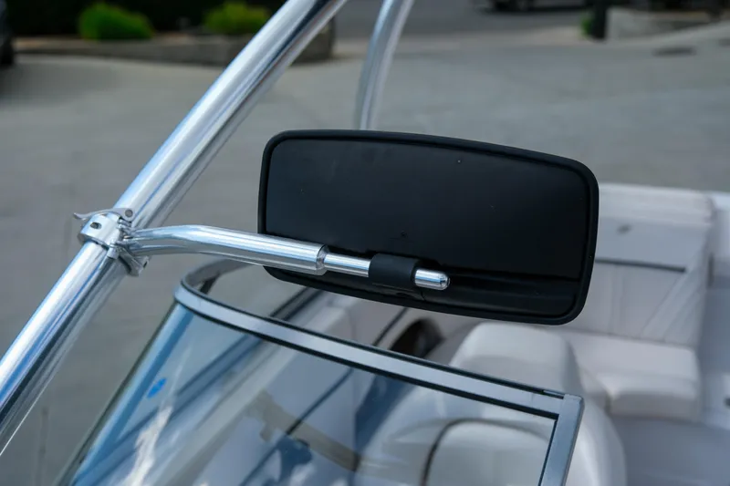Slide: The Image of Side mirror of a 2010 Four Winns 220H boat, featuring sleek design and chrome finish. - 18