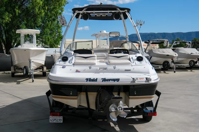 Slide: The Image of 2010 Four Winns 220H boat, rear view, parked in marina with other boats. - 5
