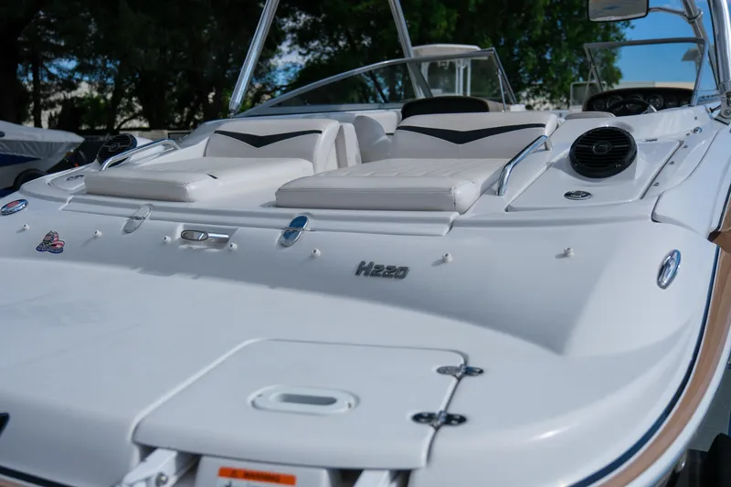 Slide: The Image of 2010 Four Winns 220H boat with white seating and sleek design. - 7