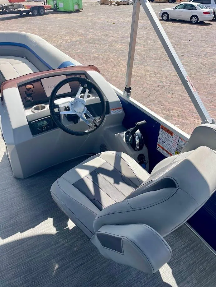 Slide: The Image of 2022 Bennington SX 23 Fishing boat interior with steering wheel and captain's chair. - 17