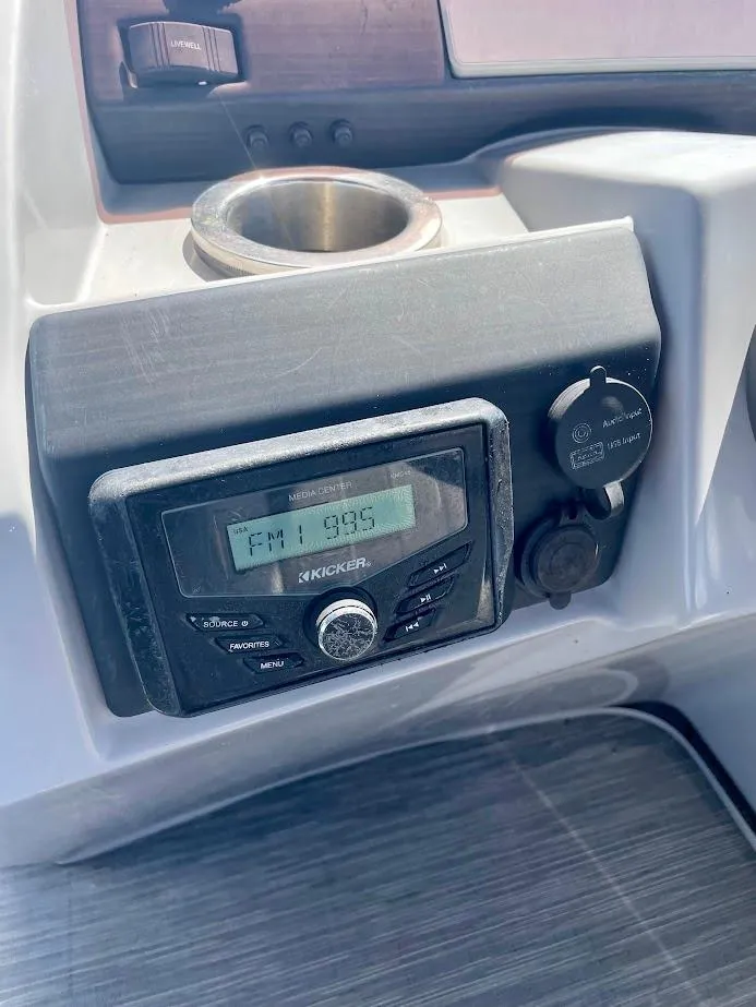 Slide: The Image of 2022 Bennington SX 23 Fishing boat console with Kicker stereo system and cup holder. - 18