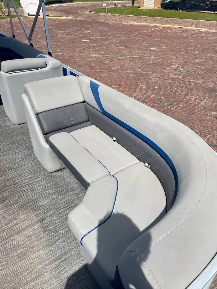 Slide: The Image of 2022 Bennington SX 23 Fishing boat with comfortable gray seating and blue accents. - 9