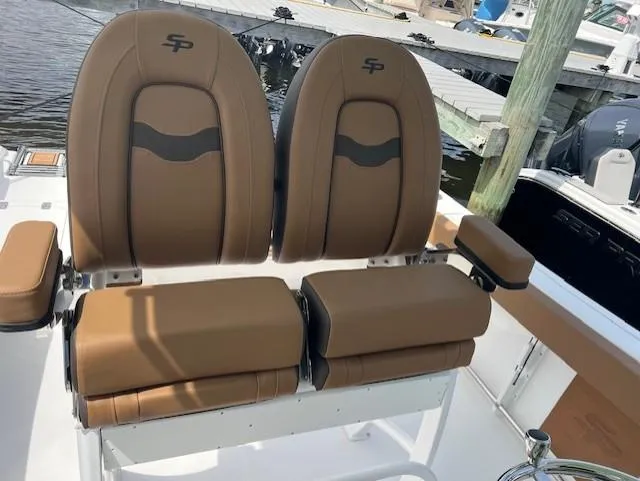 Slide: The Image of 2025 Sea Pro 242 Center Console boat seats, brown leather, docked at marina. - 10