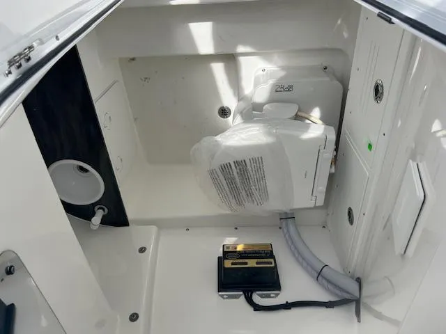 Slide: The Image of 2025 Sea Pro 242 Center Console interior compartment with equipment and wiring. - 11