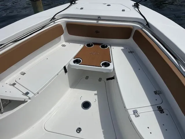 Slide: The Image of 2025 Sea Pro 242 Center Console boat interior with seating and cup holders. - 12