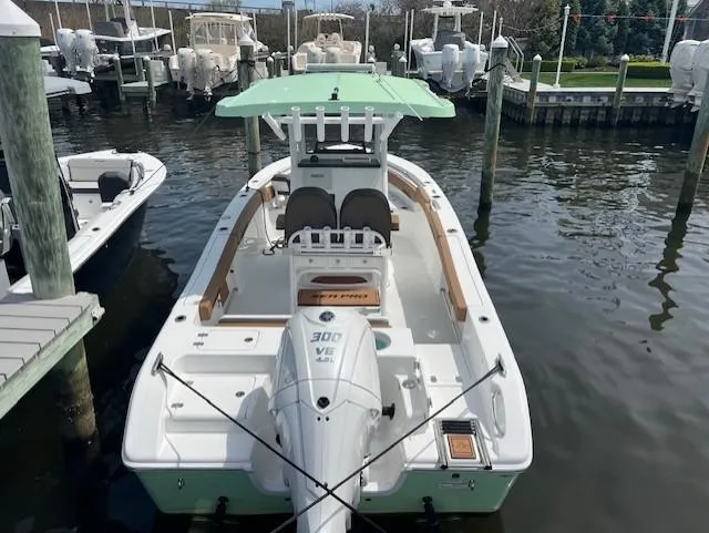Slide: The Image of 2025 Sea Pro 242 Center Console boat docked in marina, featuring a 300 V6 engine. - 3