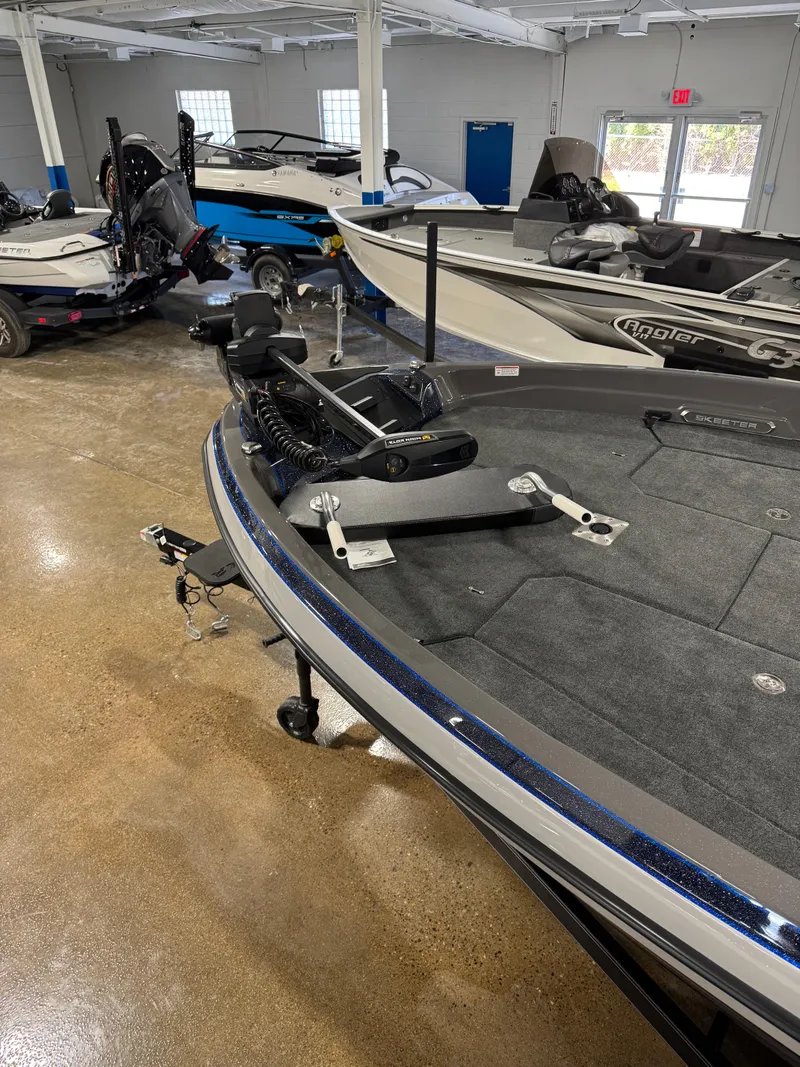 Slide: The Image of 2025 Skeeter WXR 2260 F boat in showroom, featuring sleek design and advanced equipment. - 12