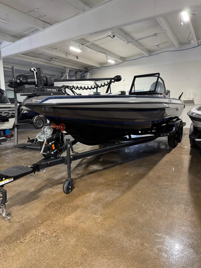 Slide: The Image of 2025 Skeeter WXR 2260 F boat on trailer in indoor showroom. - 2