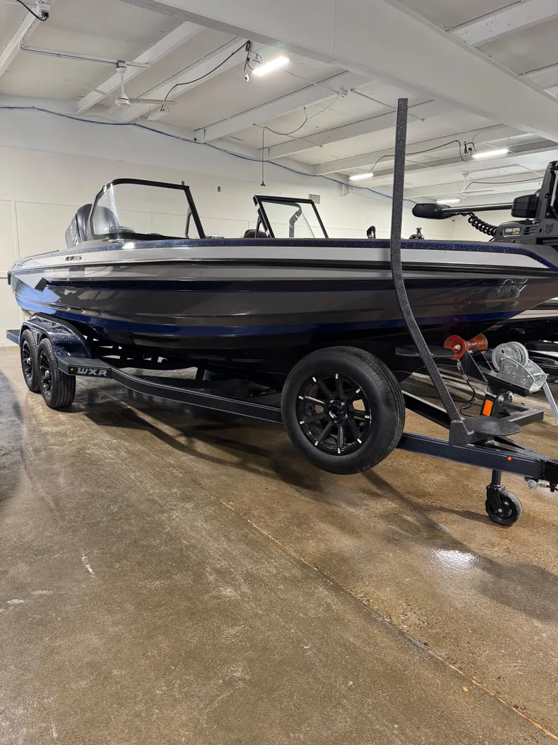 The Image of 2025 Skeeter WXR 2260 F boat on trailer in showroom setting. - 1