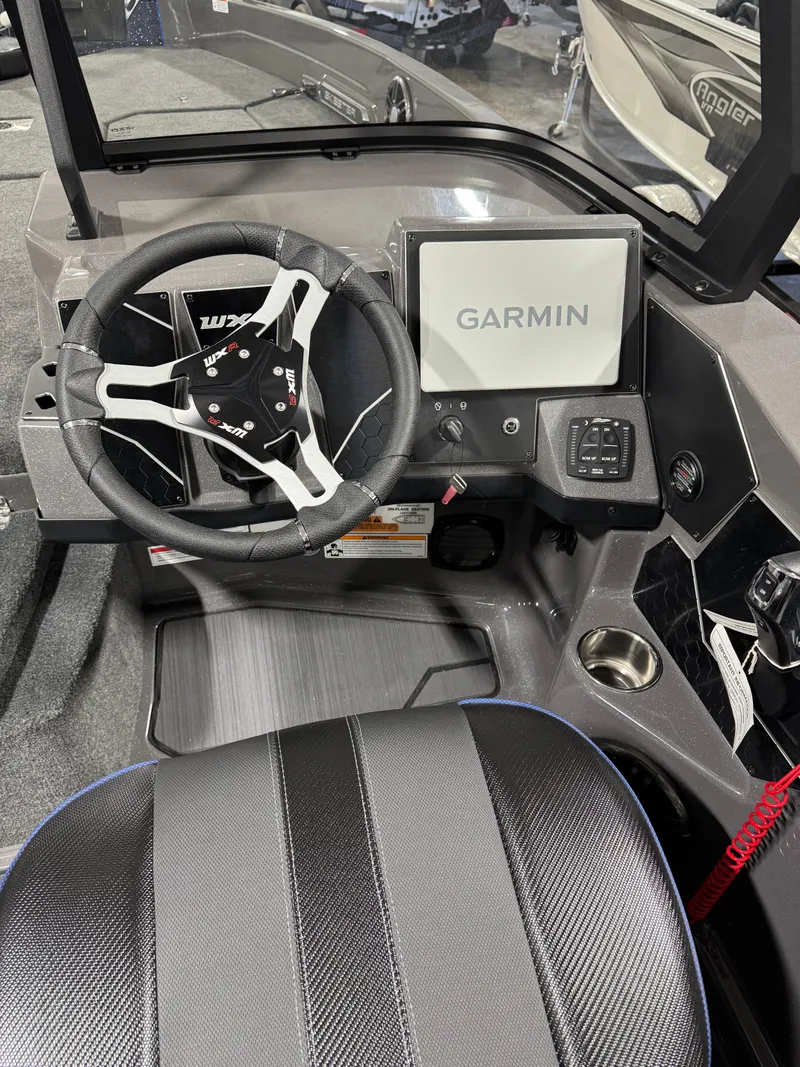 Slide: The Image of 2025 Skeeter WXR 2260 F boat cockpit with Garmin navigation system. - 15