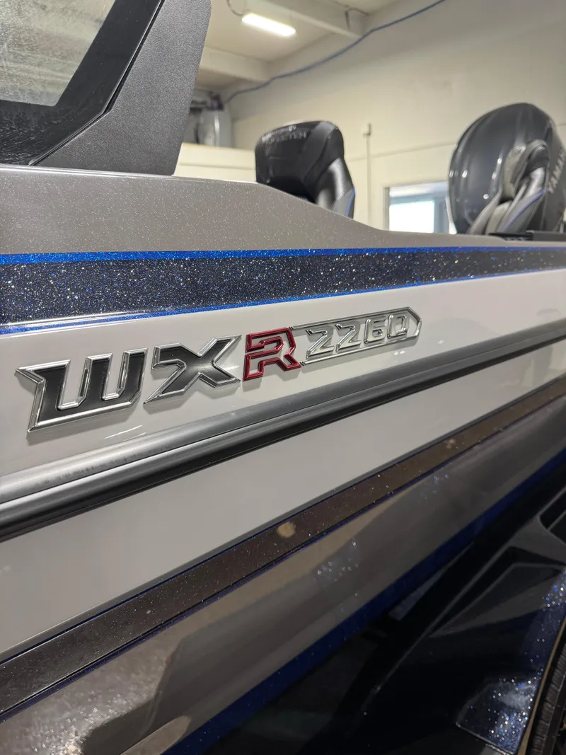 Slide: The Image of 2025 Skeeter WXR 2260 F boat, close-up of model emblem in a showroom setting. - 3