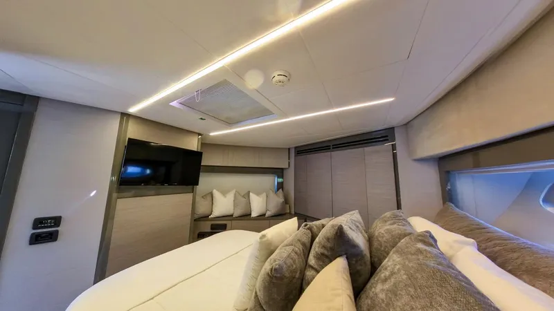Slide: The Image of Luxurious interior of a 2014 Pershing 62 yacht with modern design and cozy bedding. - 11
