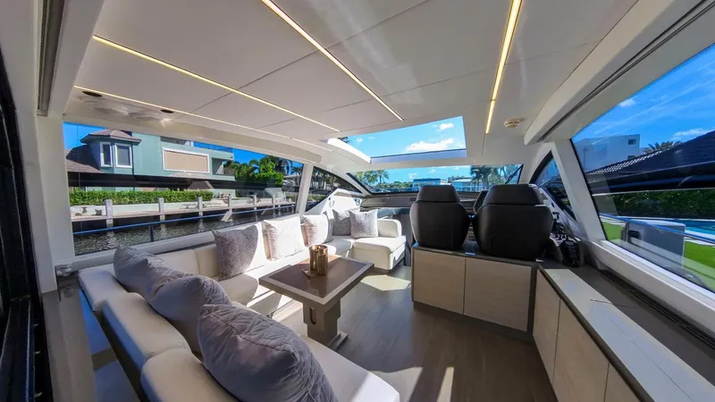Slide: The Image of Luxurious interior of a 2014 Pershing 62 yacht with modern seating and panoramic windows. - 2