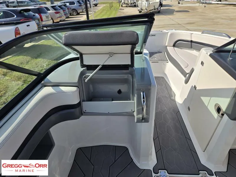 Slide: The Image of 2018 Chaparral 223VRX boat interior with open storage compartment and seating. - 10