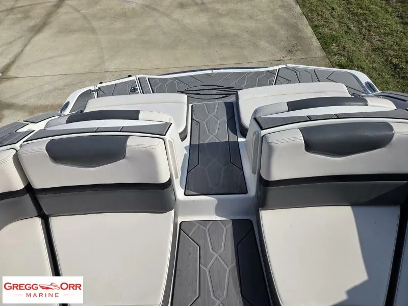 Slide: The Image of 2018 Chaparral 223VRX boat interior with gray and white seating, viewed from above. - 14