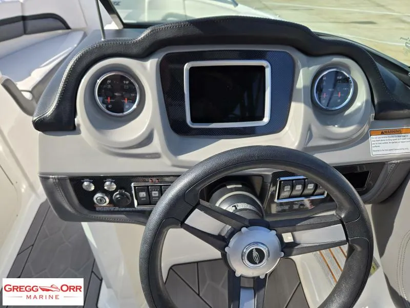 Slide: The Image of 2018 Chaparral 223VRX boat dashboard with steering wheel and gauges, Gregg Orr Marine. - 15