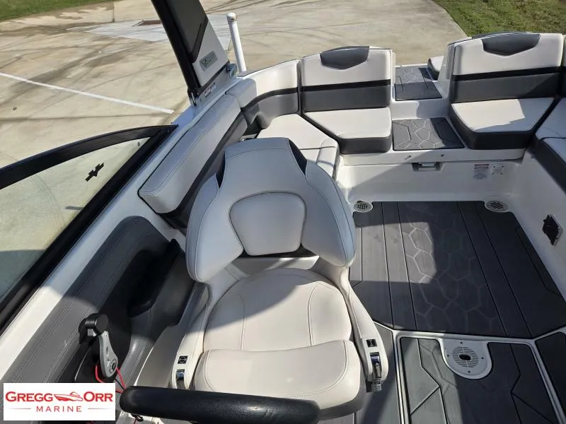 Slide: The Image of 2018 Chaparral 223VRX boat interior with white and gray seating, shown at Gregg Orr Marine. - 17