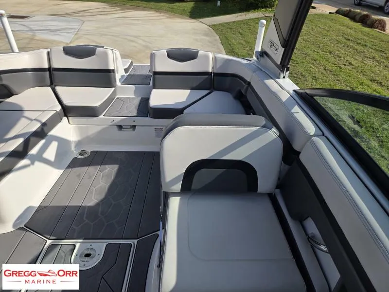 Slide: The Image of 2018 Chaparral 223VRX boat interior with gray seating and flooring, displayed at Gregg Orr Marine. - 18