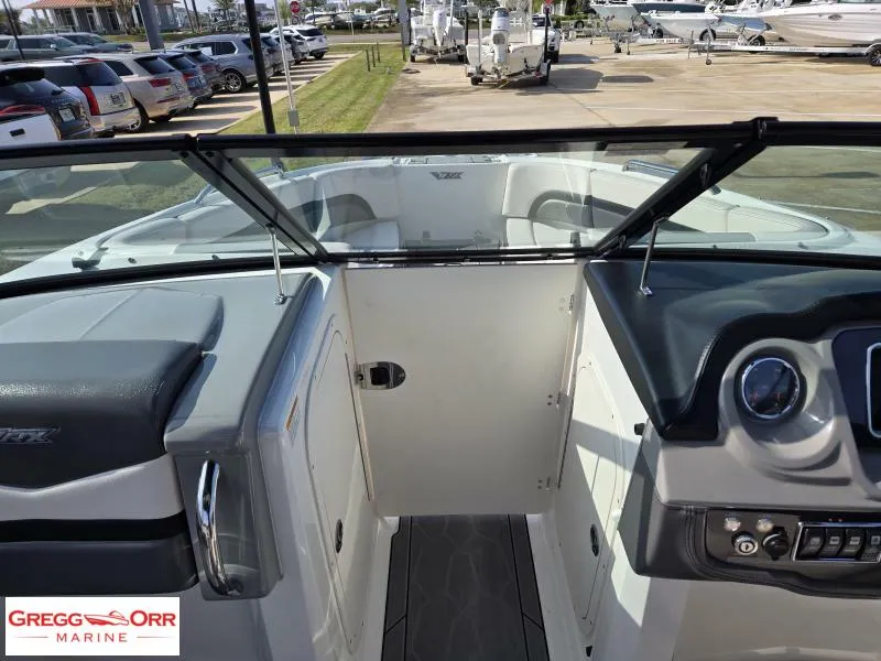 Slide: The Image of 2018 Chaparral 223VRX boat interior with open windshield and dashboard view at Gregg Orr Marine. - 8