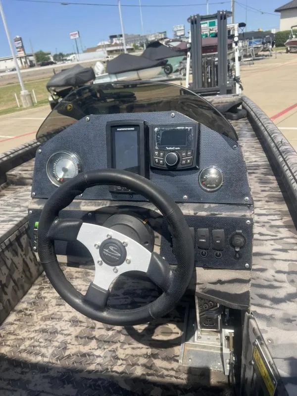 Slide: The Image of 2020 Havoc Boats 1753 RR dashboard with steering wheel and control panel. - 10