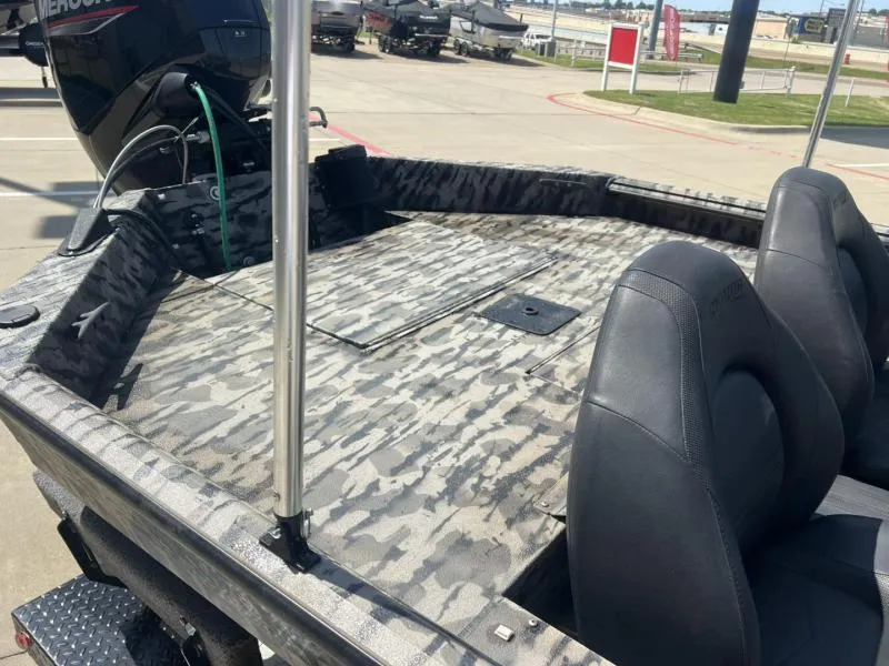 Slide: The Image of 2020 Havoc Boats 1753 RR with camouflage deck and dual seats, parked outdoors. - 13