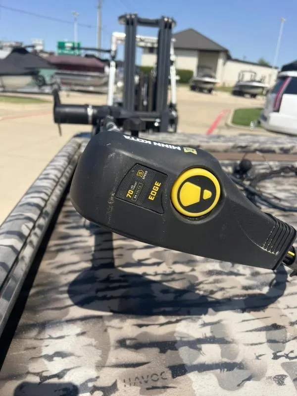 Slide: The Image of Minn Kota trolling motor on 2020 Havoc Boats 1753 RR, camo pattern, outdoor setting. - 17