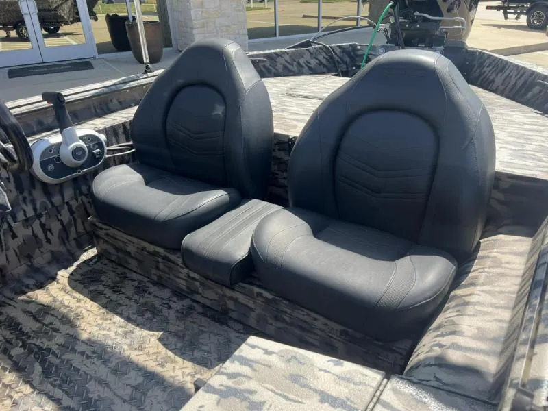 Slide: The Image of 2020 Havoc Boats 1753 RR interior with two black seats and camouflage flooring. - 19