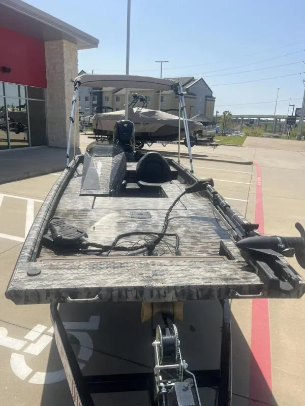 Slide: The Image of 2020 Havoc Boats 1753 RR parked outside, showcasing its deck and motor. - 8