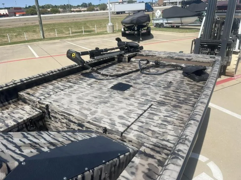 Slide: The Image of 2020 Havoc Boats 1753 RR with camouflage pattern, parked outdoors. - 9