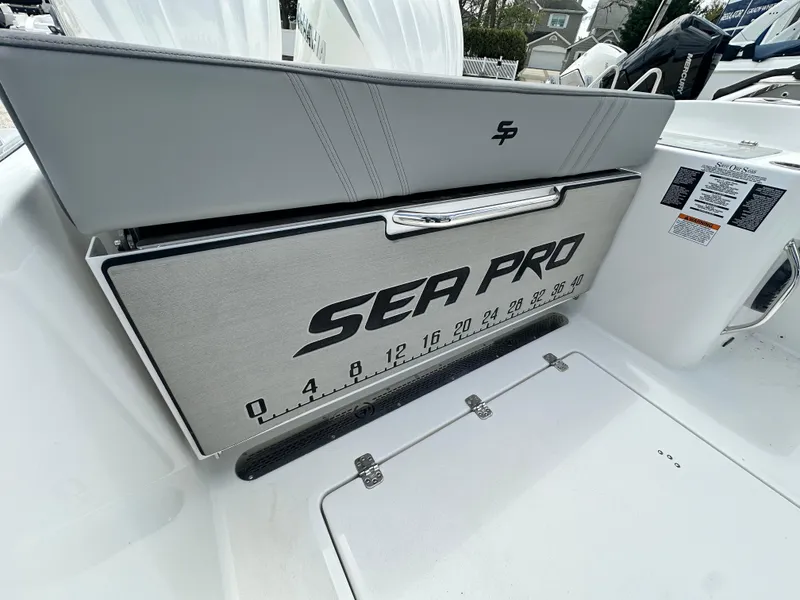 Slide: The Image of 2025 Sea Pro 292 Offshore boat interior with branded storage compartment and measurement scale. - 11