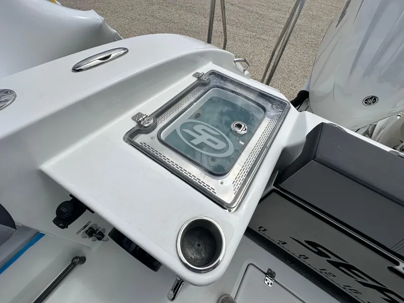 Slide: The Image of 2025 Sea Pro 292 Offshore boat deck with storage compartment and cup holder. - 13
