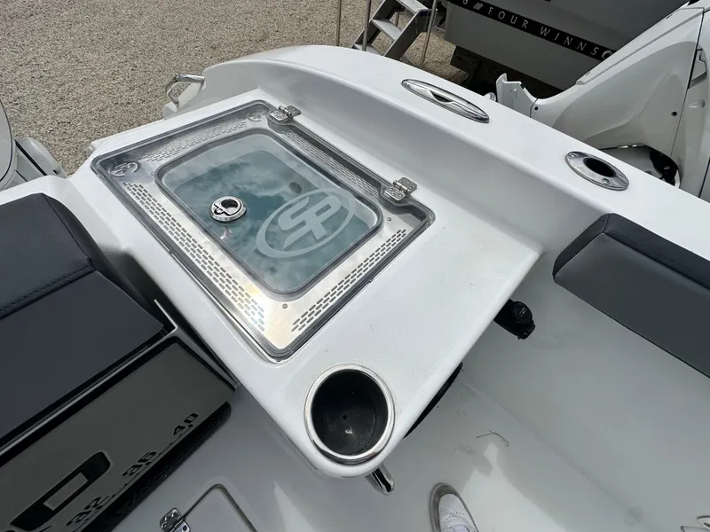 Slide: The Image of 2025 Sea Pro 292 Offshore boat deck with storage compartment and cup holders. - 14